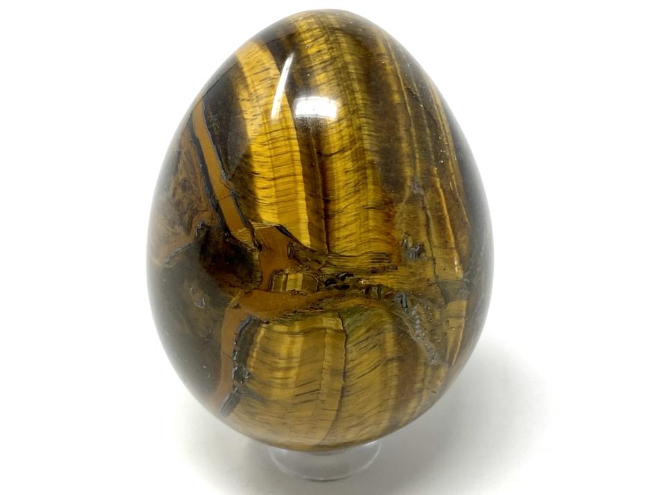 Flashy Gold Tiger's Eye Crystal Egg Shape On Display Stand With Chatoyant Cat's Eye Effect And Gold Stripes